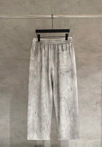 Light gray Chrome pants with elastic waist, white drawstrings, and side pocket