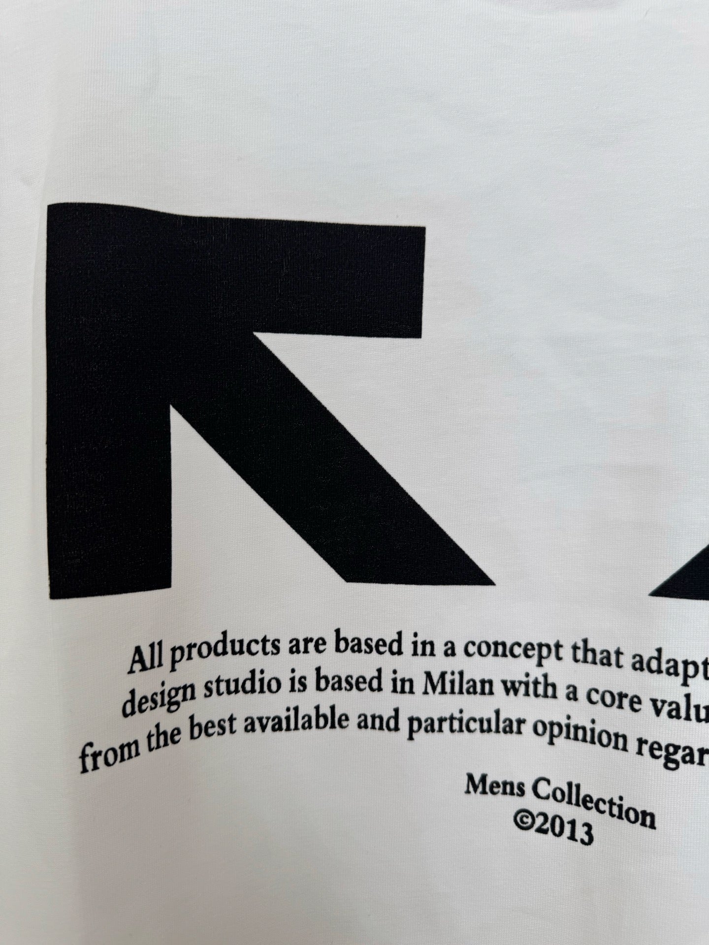 Off-White white T-shirt fabric with black arrow graphic and text, close-up