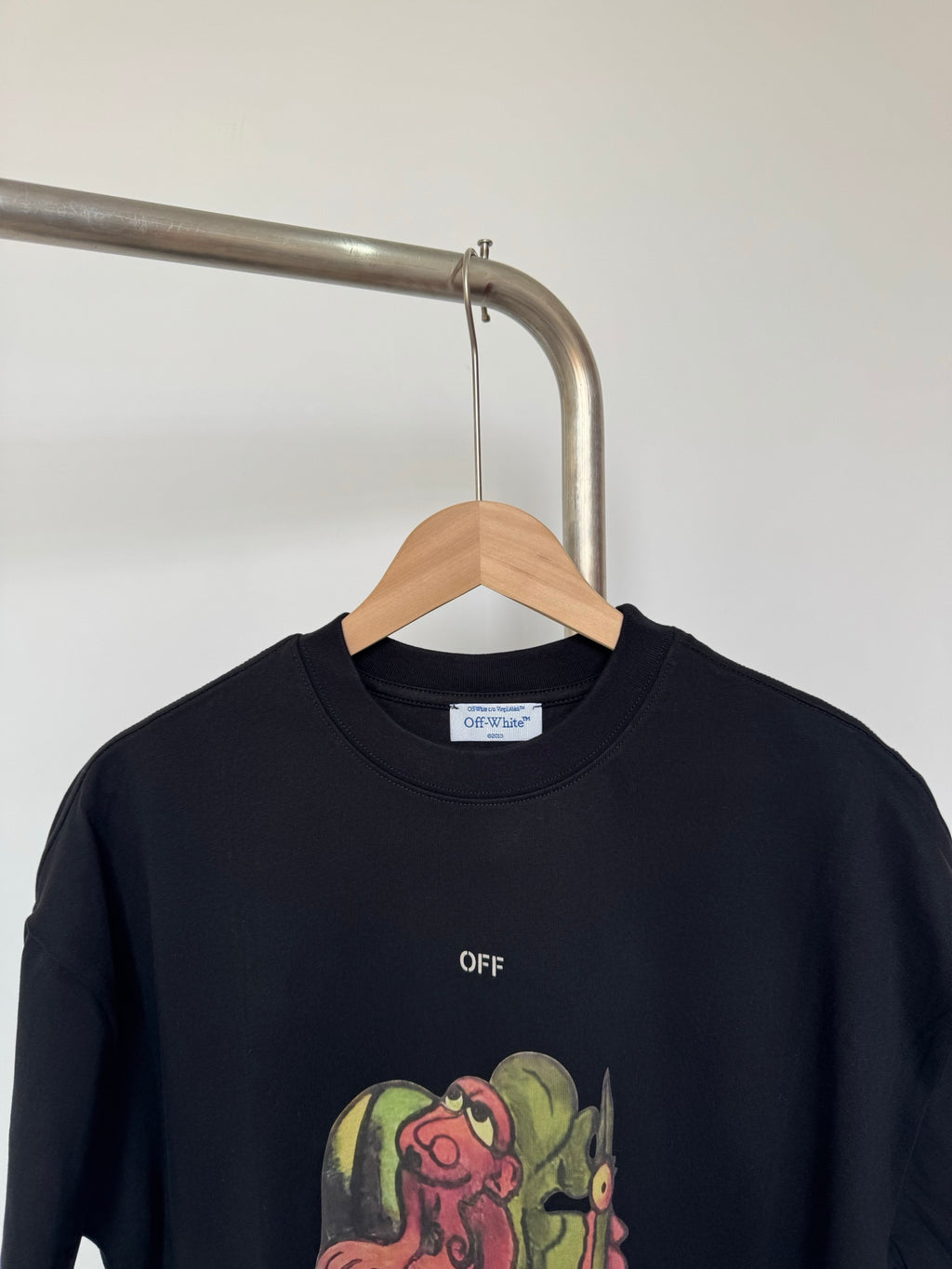 Black T-shirt with 'OFF' text and partial colorful character graphic