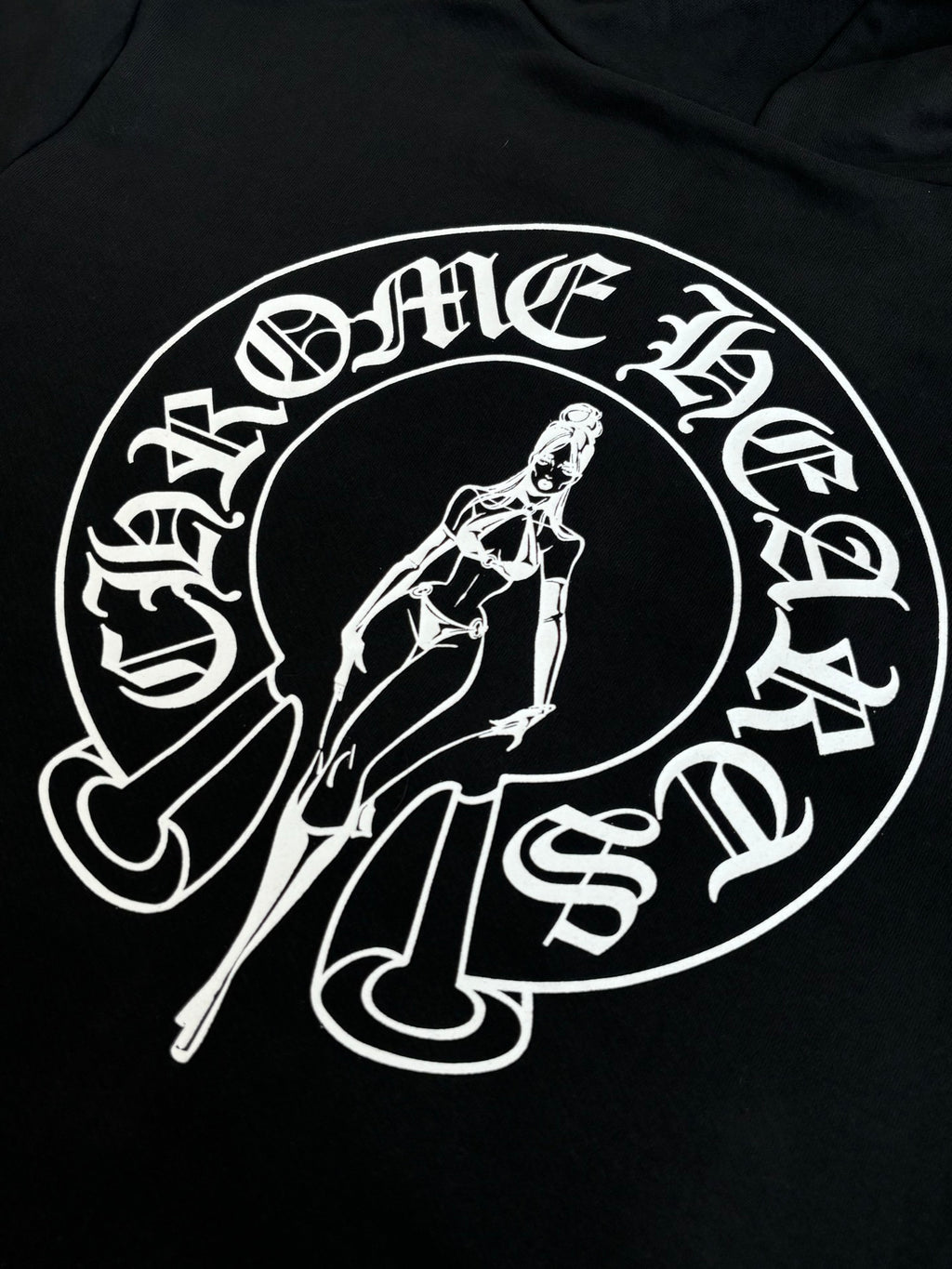 Black hoodie with large white oval graphic print and sword-themed illustration