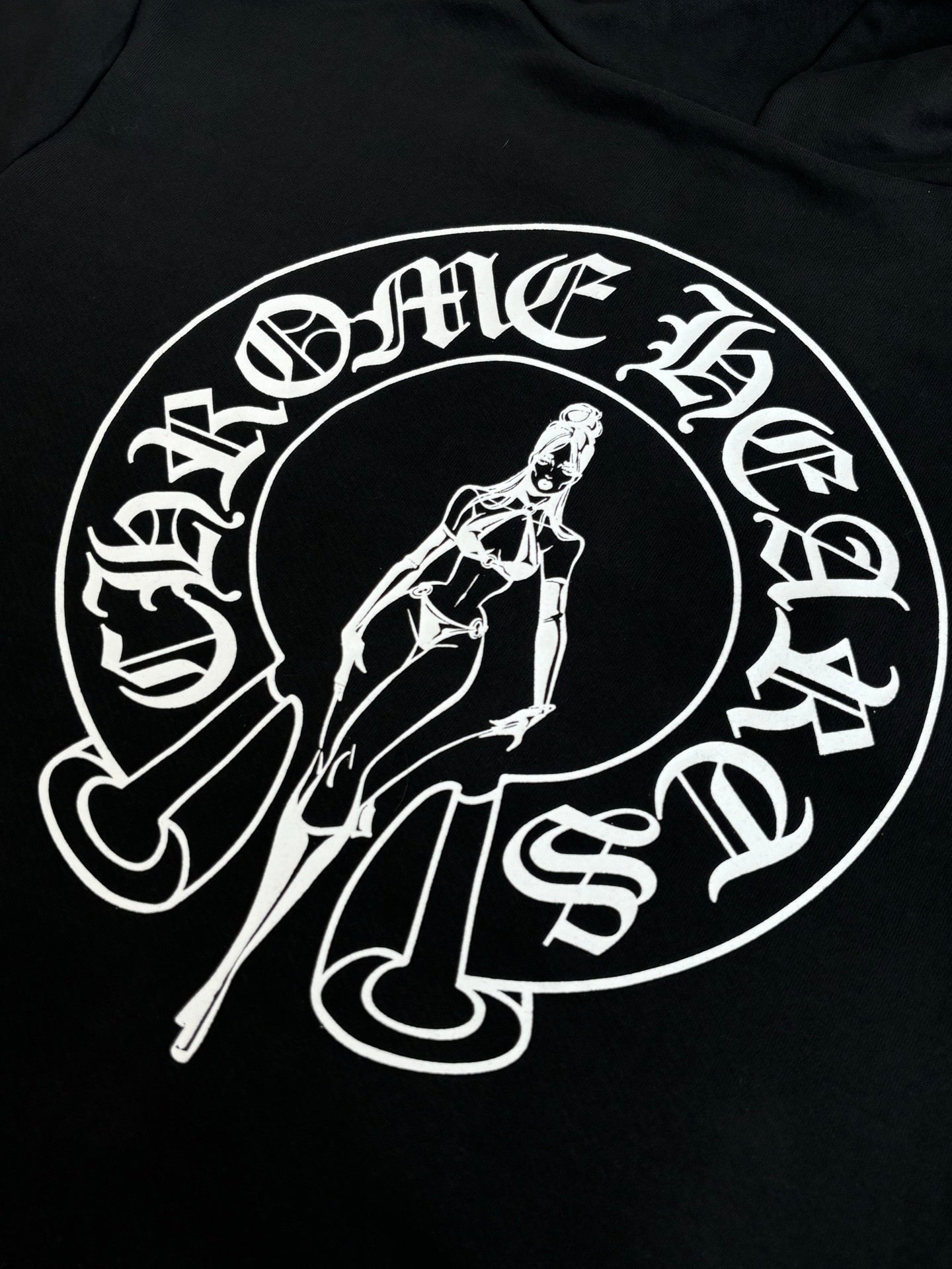 Black hoodie with large white oval graphic print and sword-themed illustration