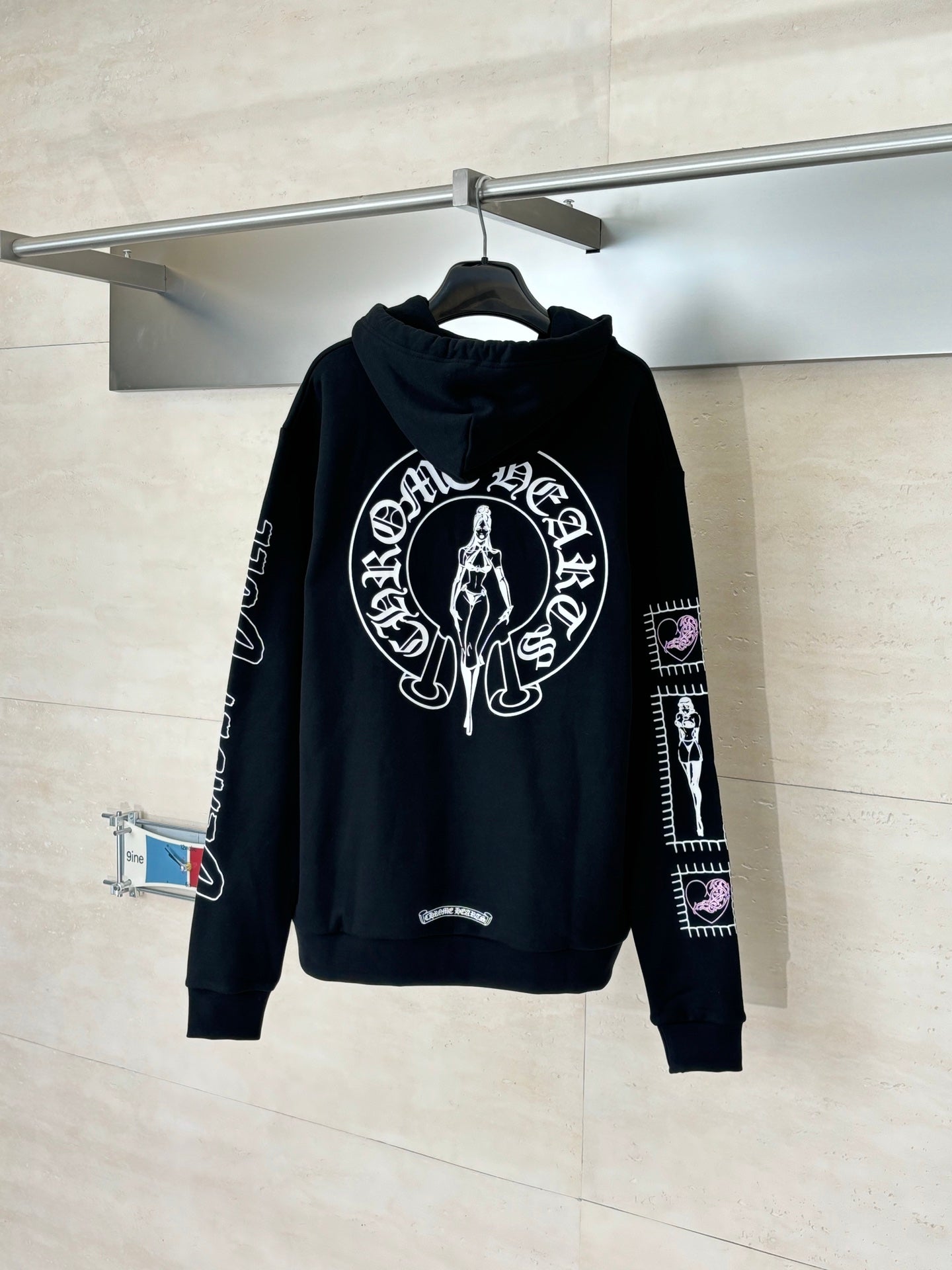 Black zip-up hoodie with hood and large white graphic print on chest, sleeve logos