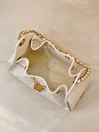 Chanel quilted white leather bucket bag open view with gold chain strap and interior lining