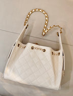 Chanel quilted white leather bucket bag with gold chain handles and front CC logo hardware