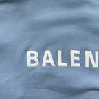 Light blue top with Balenciaga logo lettering, partial 'BALEN' print