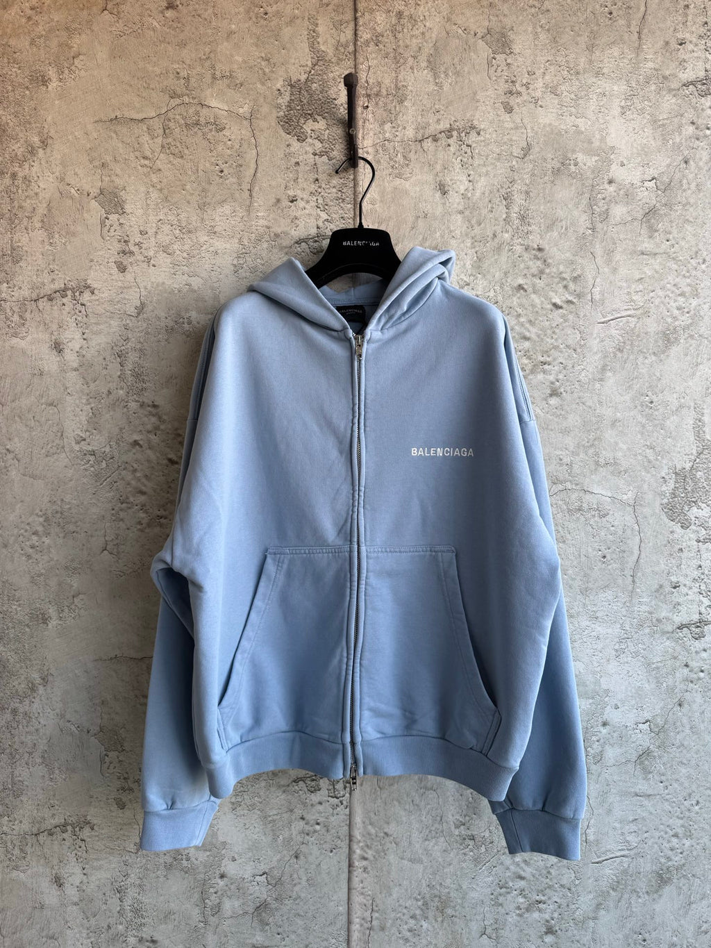 Balenciaga light blue zip-up hoodie with front pockets and hood