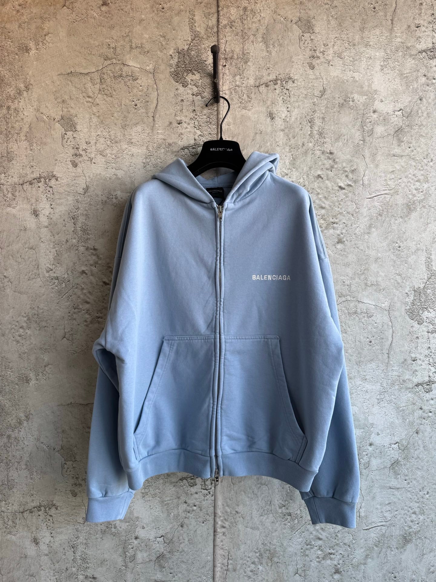 Balenciaga light blue zip-up hoodie with front pockets and hood
