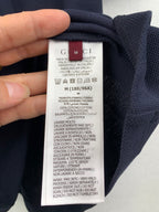 Polo shirt care label showing size and washing instructions