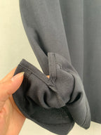 Navy polo shirt sleeve gathered at cuff with textured knit surface
