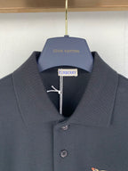 Navy Burberry polo shirt close-up of collar and center logo detail