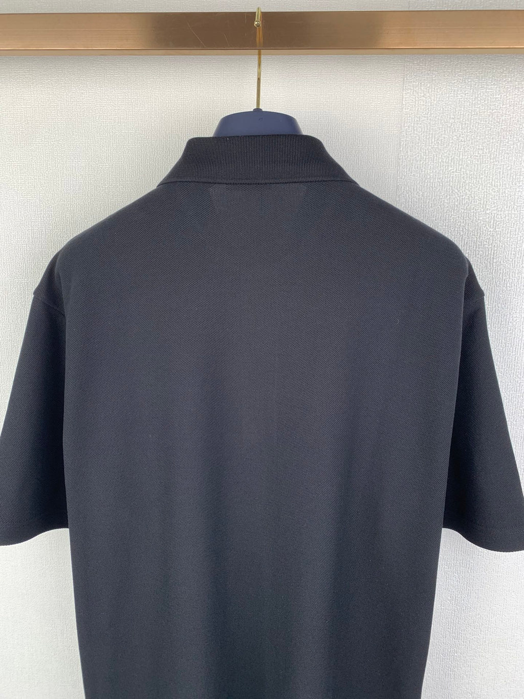 Navy Burberry polo shirt back view with stand collar and short sleeves