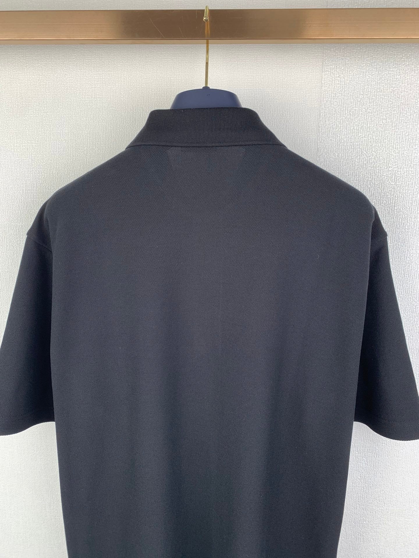 Navy Burberry polo shirt back view with stand collar and short sleeves
