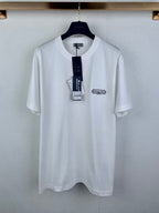 White short-sleeve T-shirt with Dior logo chest patch, on a hanger