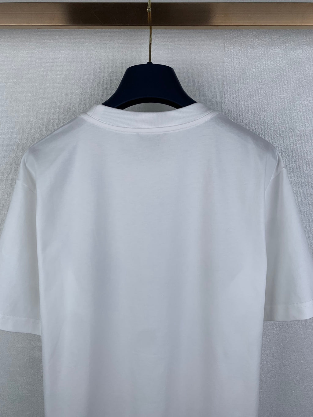 White short-sleeve T-shirt back close-up on hanger