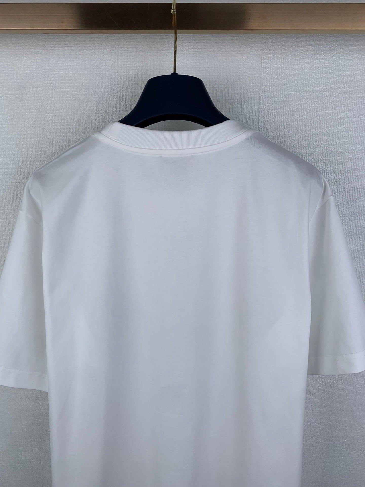 White short-sleeve T-shirt back close-up on hanger