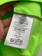 Neon green T-shirt care label, cotton content and Made in Italy