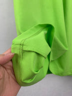 Neon green T-shirt sleeve cuff with reinforced stitching