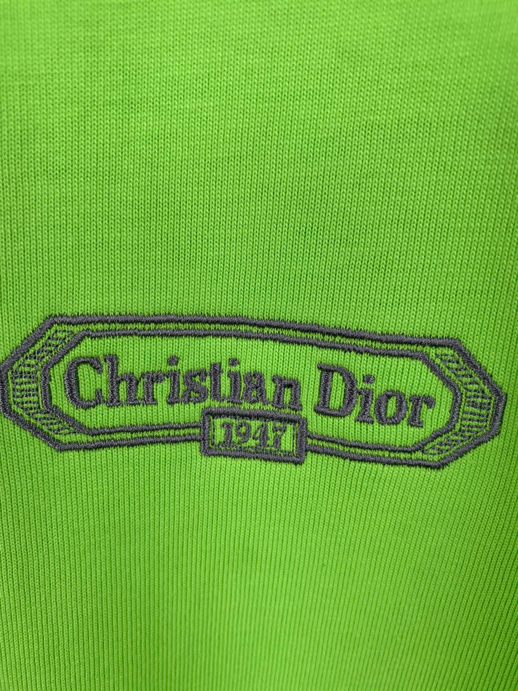 Green T-shirt with embroidered 'Christian Dior' logo patch