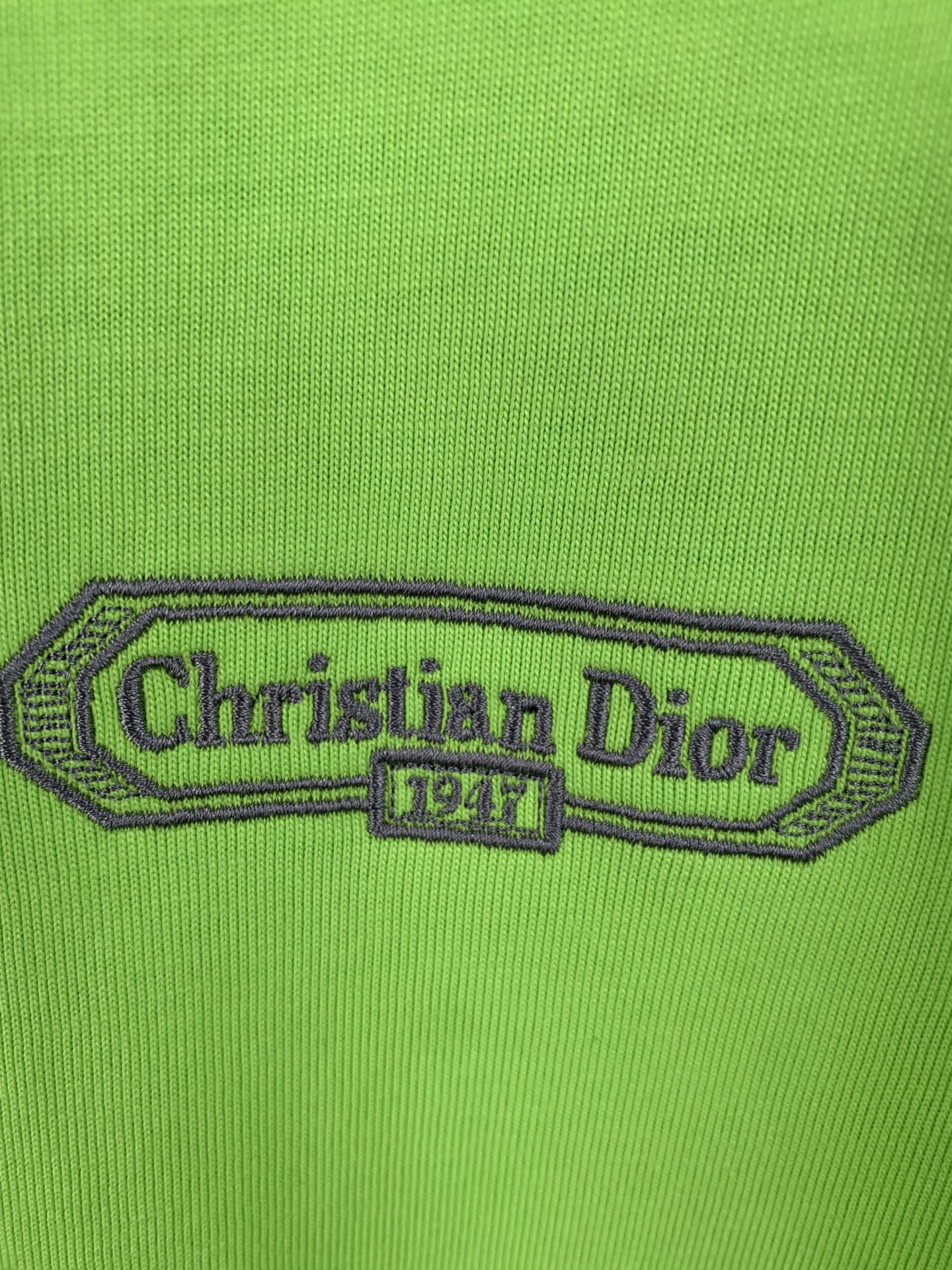 Green T-shirt with embroidered 'Christian Dior' logo patch