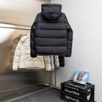Black hooded puffer jacket on hanger, front view with zipper and padded quilting