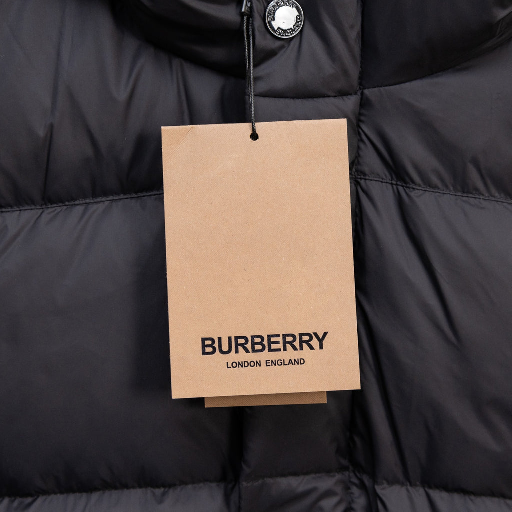 Black puffer jacket with hanging Burberry London England tag on front