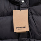 Black puffer jacket with hanging Burberry London England tag on front