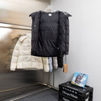 Black hooded puffer jacket back view with padded panels and buttoned side tabs