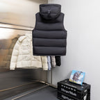 Black hooded puffer vest with high collar and sleeveless quilted baffles