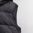 Black sleeveless puffer vest with side seam paneling and zipper trim