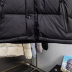 Long black puffer jacket with front buttons and quilted panels