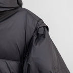 Black puffer jacket side view with seam stitching and smooth outer fabric