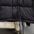 Black puffer vest front with button closures and quilted horizontal baffle lines