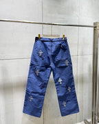 Blue pants with cross appliques across the back and button closure