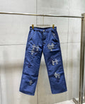 Blue pants with stitched cross appliques on both legs