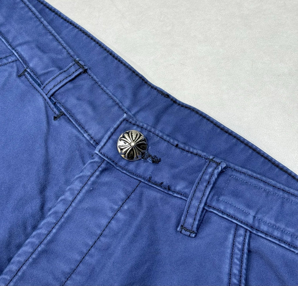 Blue pants with decorative fly button and stitched waistband seam
