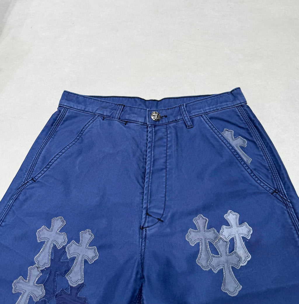 Blue pants waistband with belt loops and large cross appliques on front