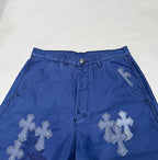 Blue pants waistband with belt loops and large cross appliques on front