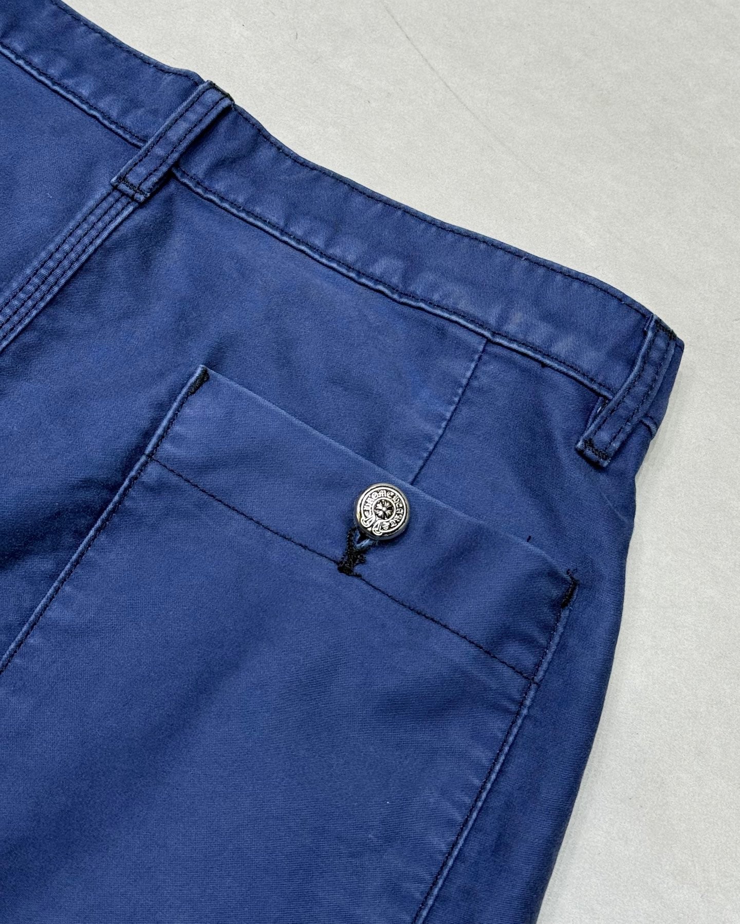 Blue pants with back pocket and round button on waistband