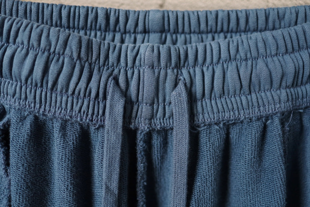 Blue pants with ruched elastic waistband and fabric pleats