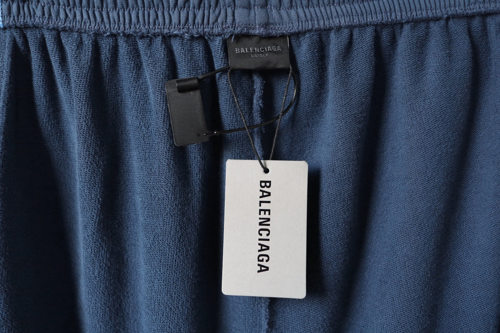 Blue pants with Balenciaga hang tag at the waistband