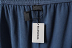 Blue pants with Balenciaga hang tag at the waistband