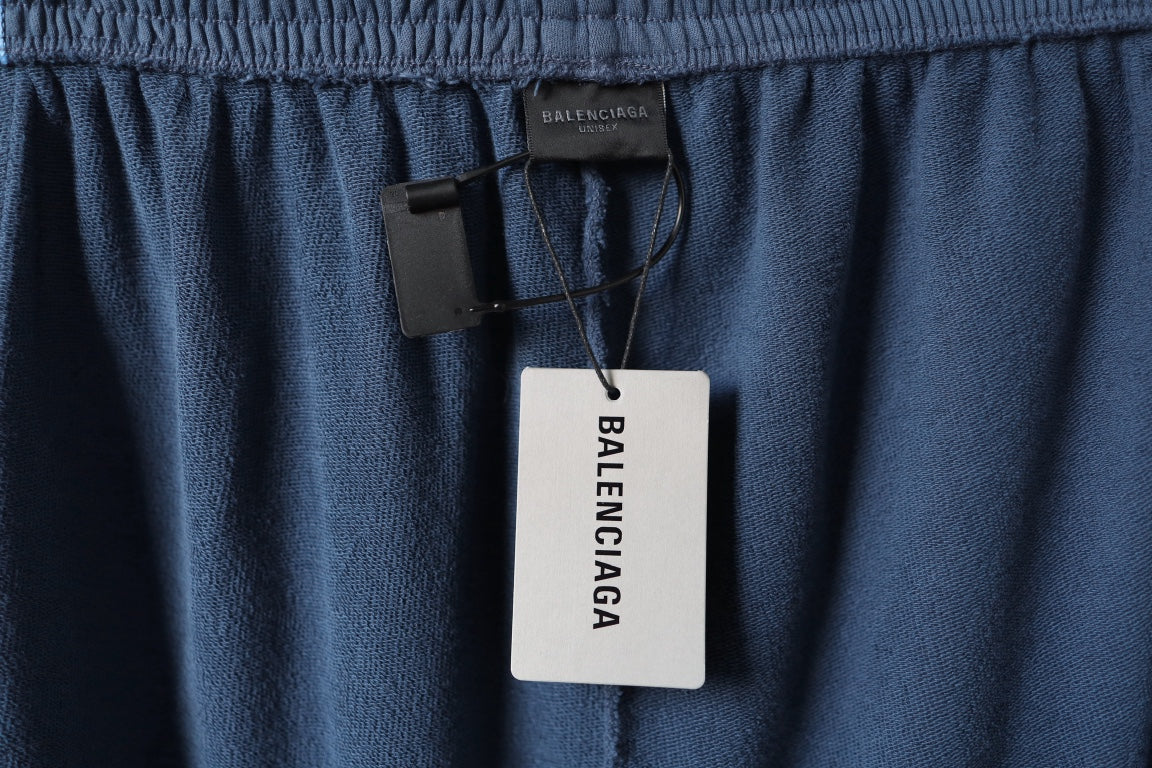 Blue pants with Balenciaga hang tag at the waistband
