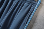 Blue pleated pants with contrast side stripe detail