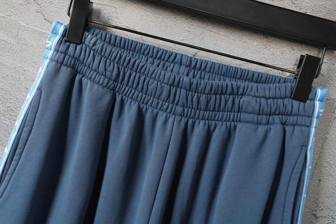 Blue pants with gathered elastic waistband and contrast side stripe