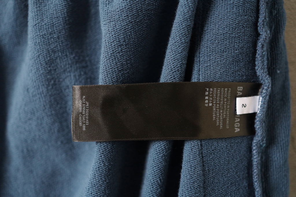 Blue pants with interior brand size label near waistband