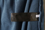 Blue pants with interior brand size label near waistband
