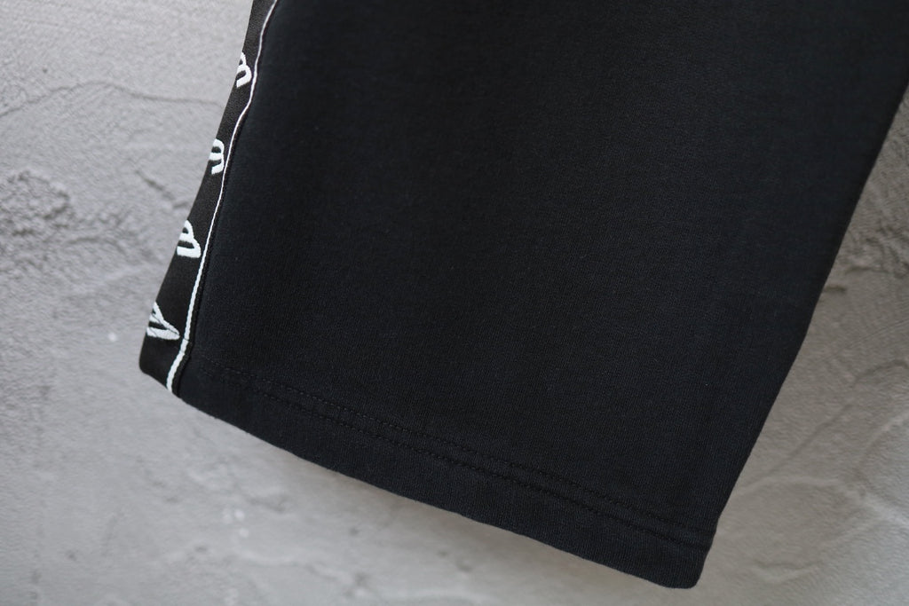 Balenciaga pants hem with black fabric and white side trim
