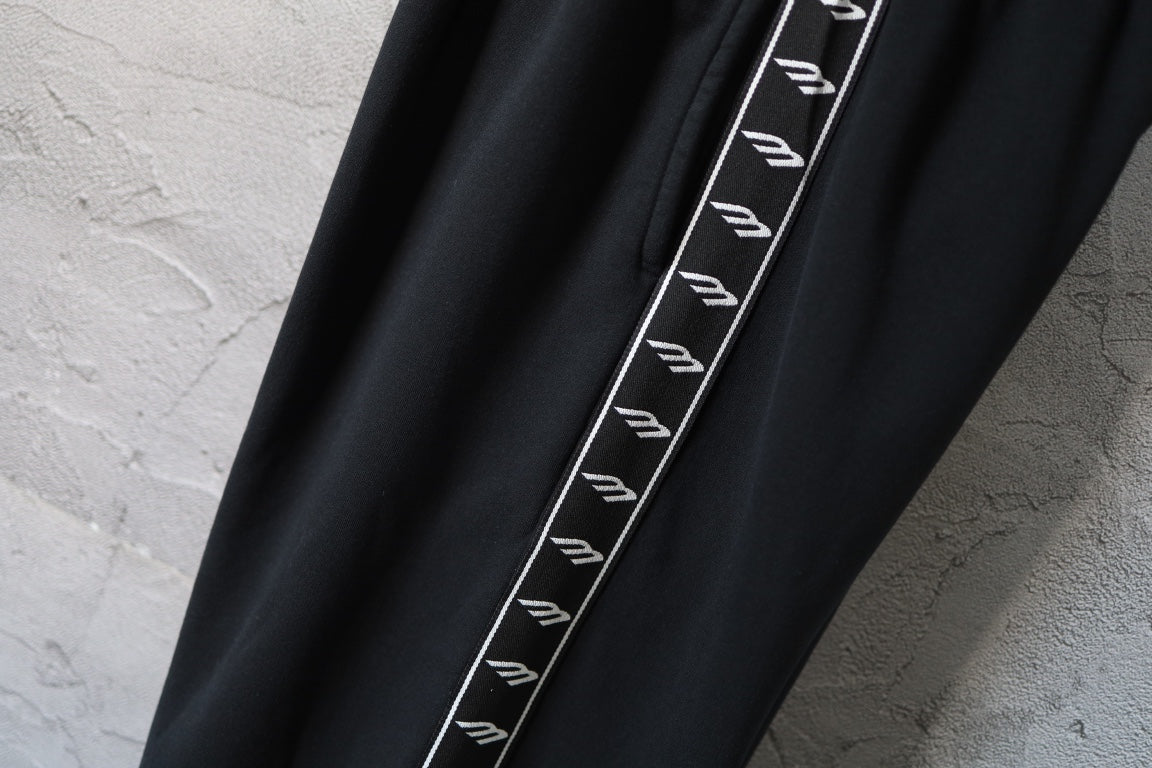 Balenciaga black pants with contrast side stripe and repeating logo print