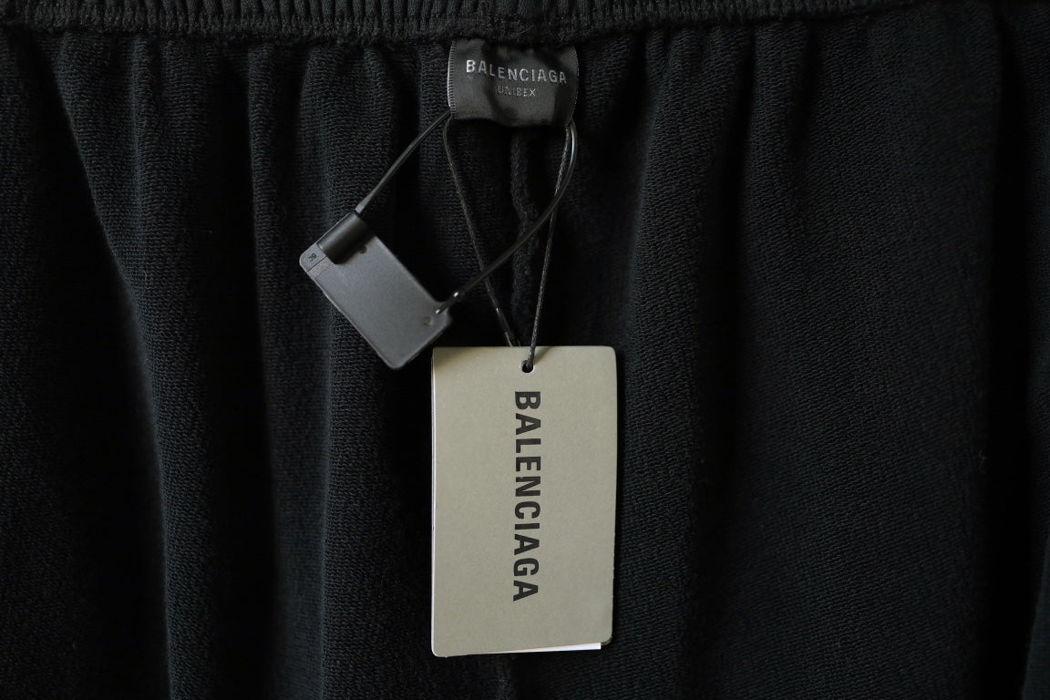Balenciaga black pants with elastic waistband and attached product hang tag