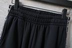Balenciaga pants waistband with gathered elastic and white side piping, black